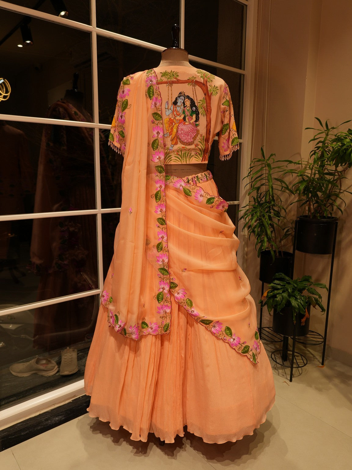 Pastel rust orange hand painted radha krishna ji pichwai lehenga set