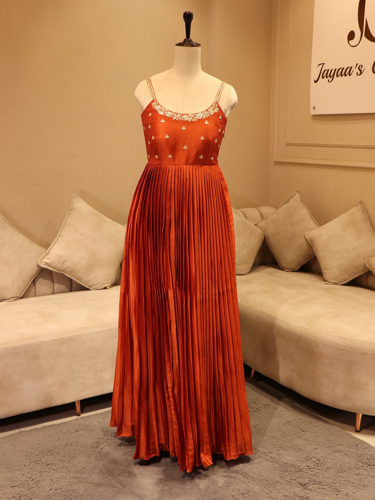 Deep rust orange pleted gown
