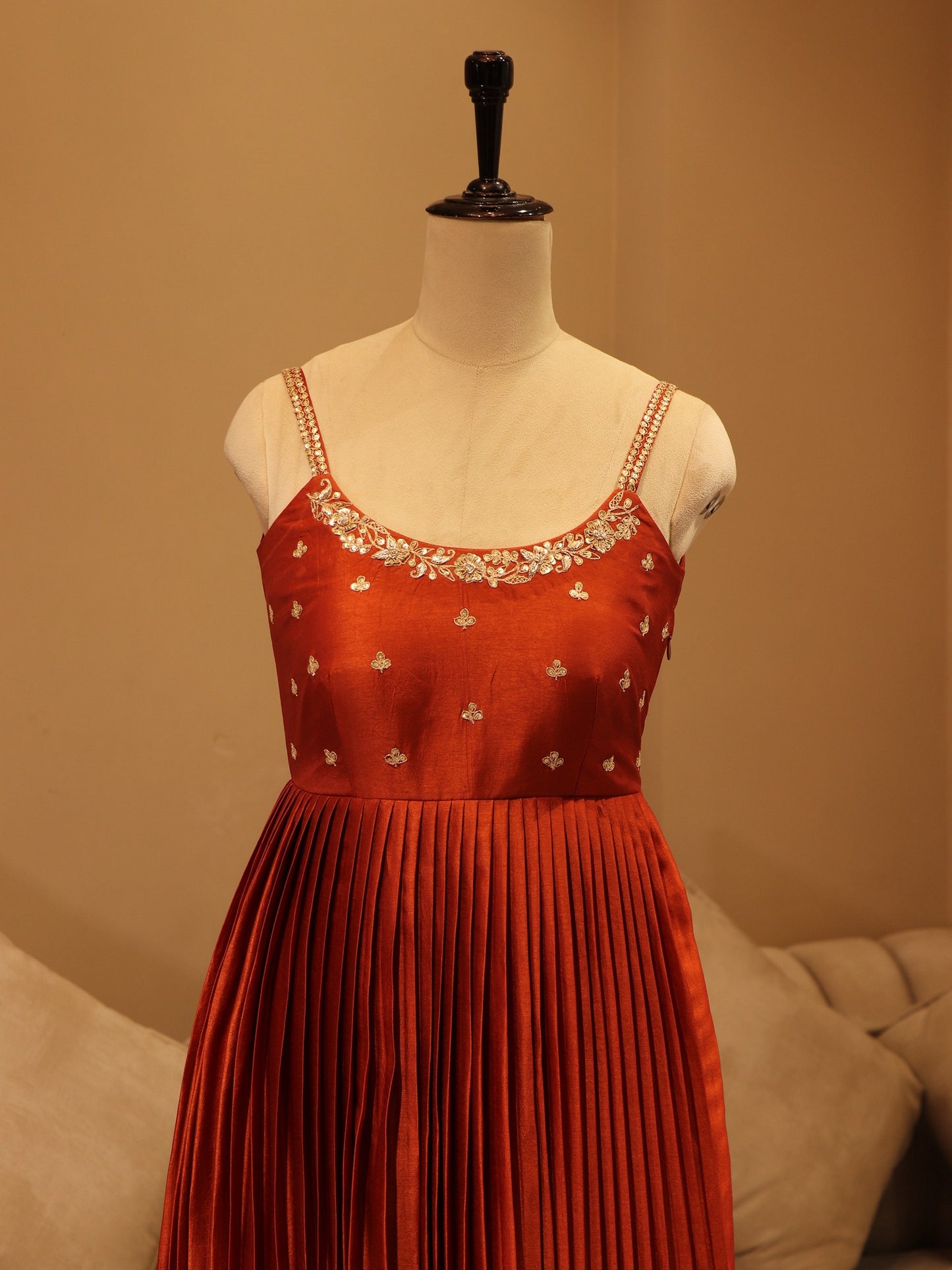 Deep rust orange pleted gown