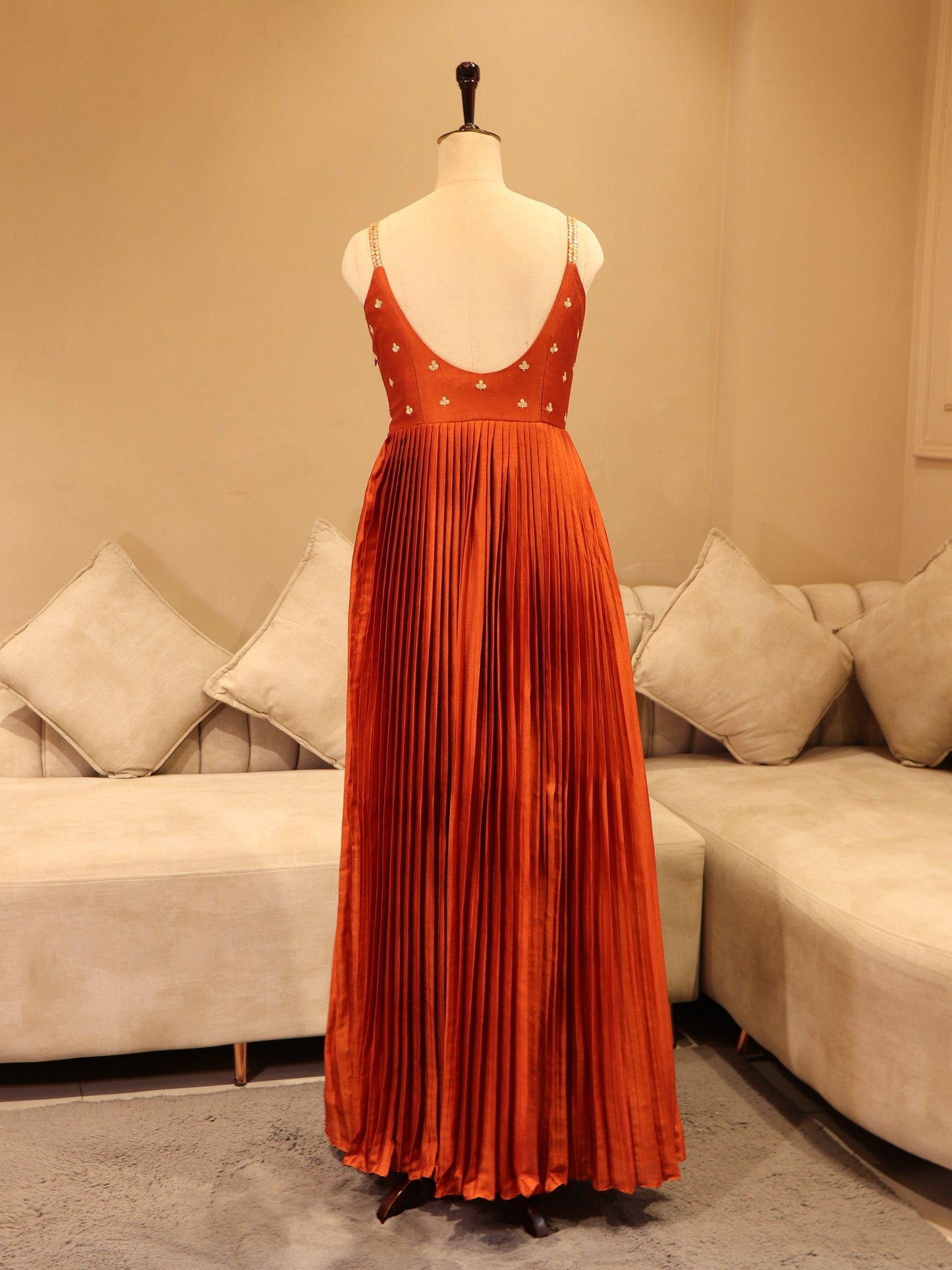 Deep rust orange pleted gown