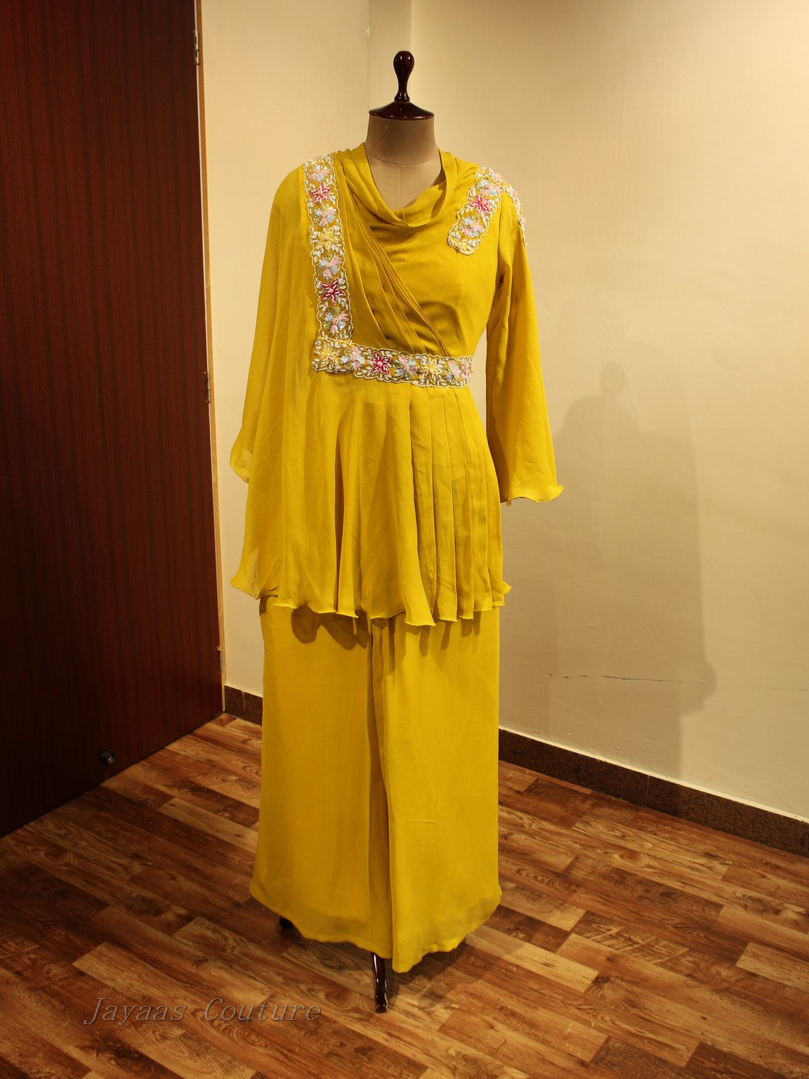 Yellow peplum top with flaired pants
