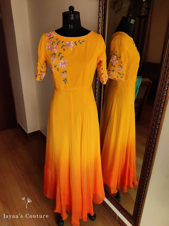 orange shaded Gown Paired up with Leheriya Dupatta.