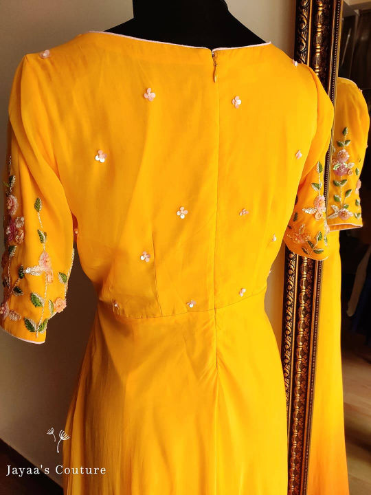 orange shaded Gown Paired up with Leheriya Dupatta.