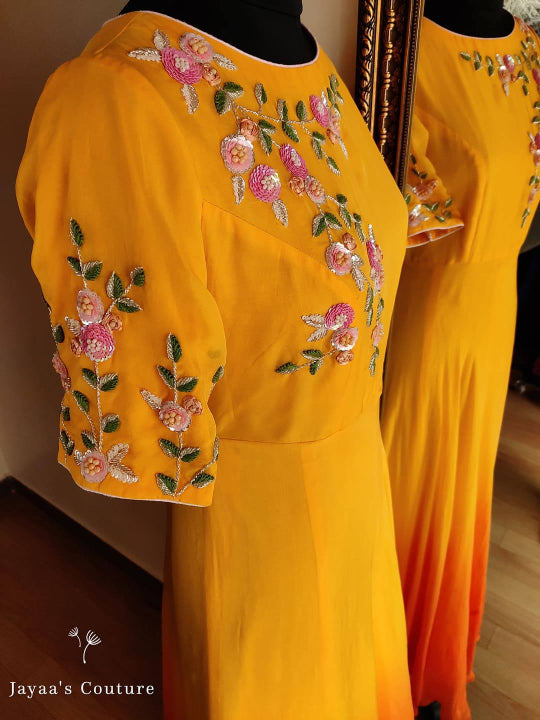 orange shaded Gown Paired up with Leheriya Dupatta.