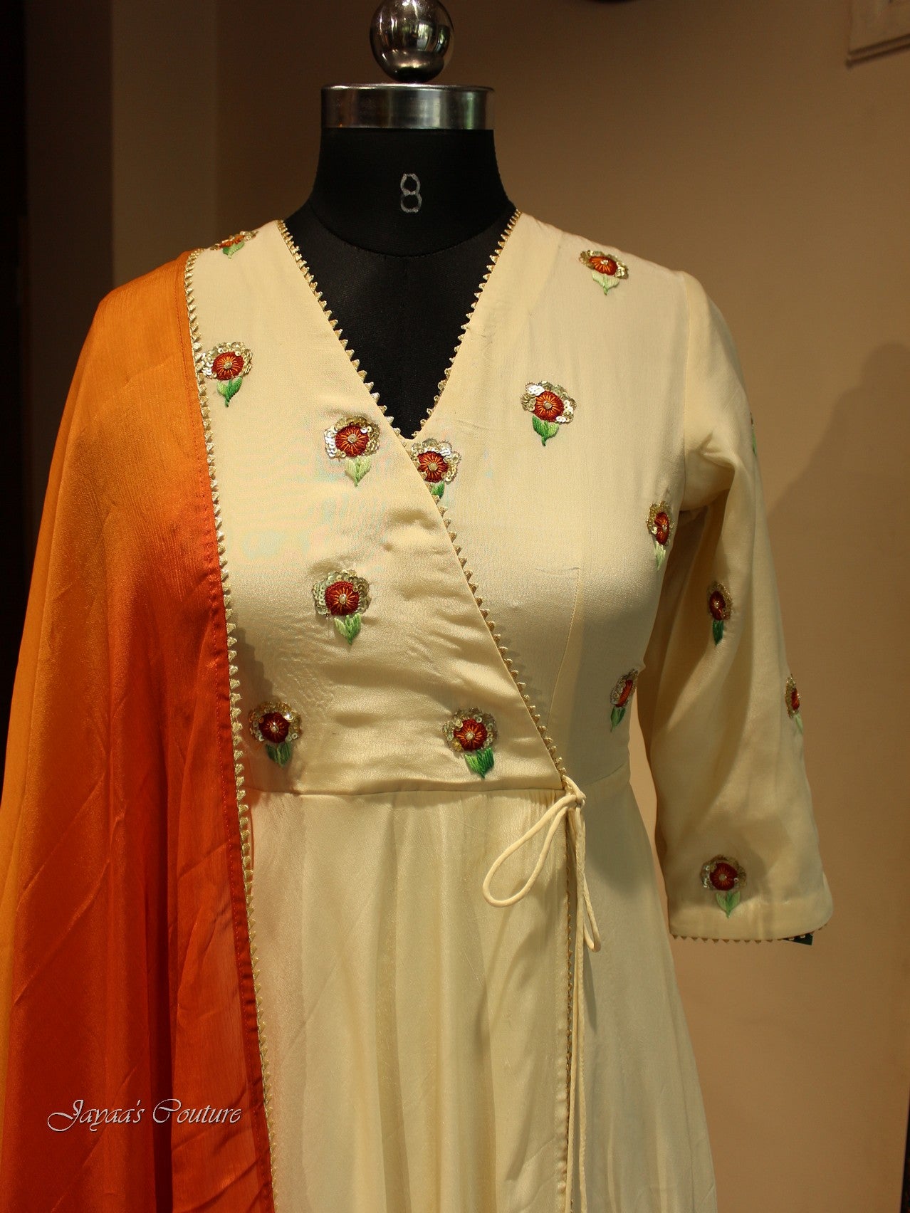 Off white gown with red orange shaded dupatta