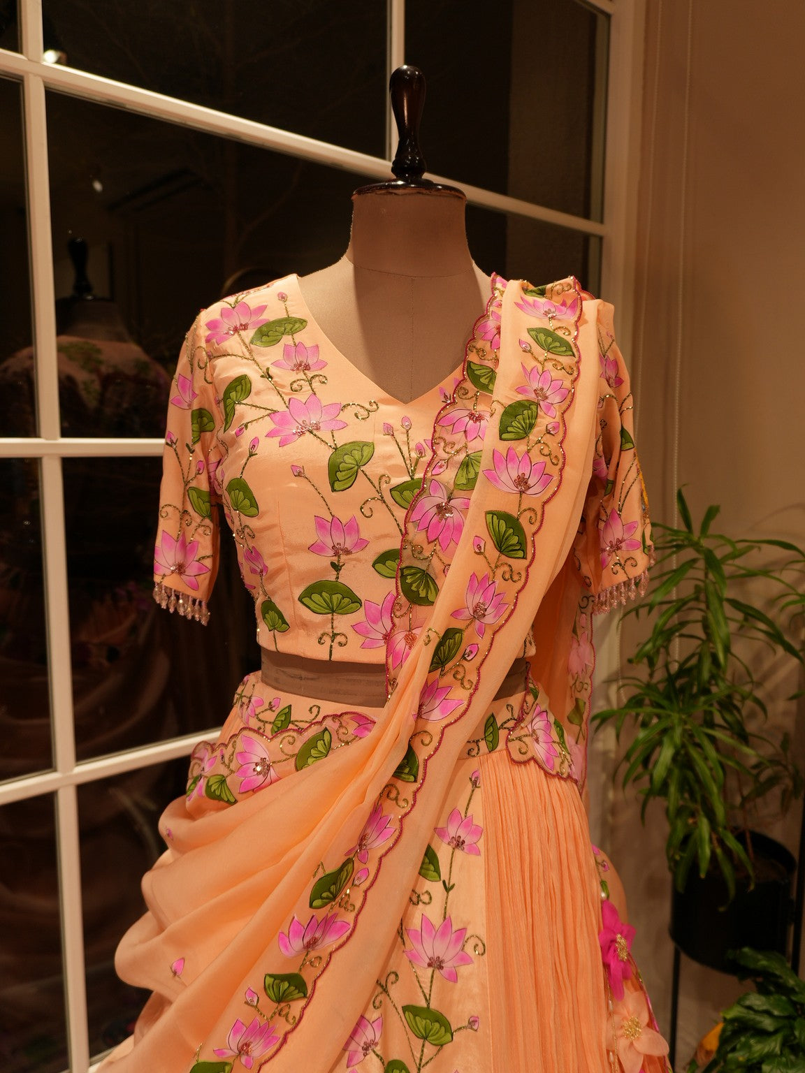 Pastel rust orange hand painted radha krishna ji pichwai lehenga set