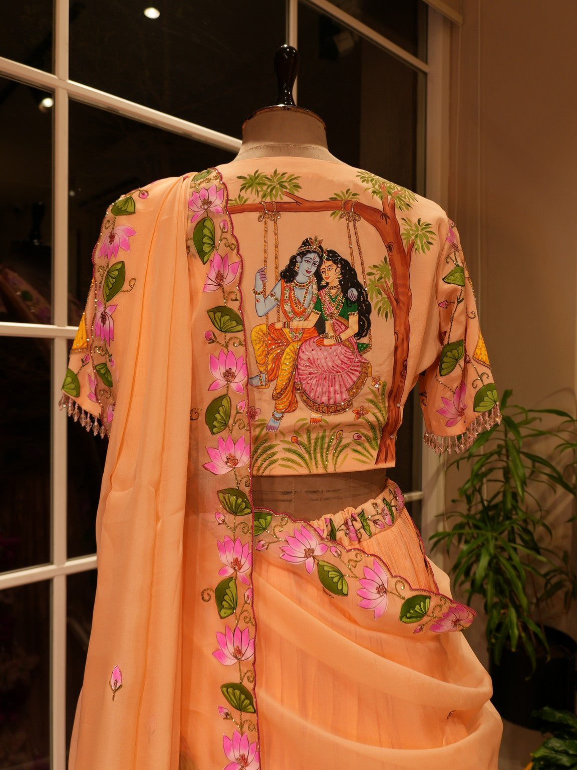 Pastel rust orange hand painted radha krishna ji pichwai lehenga set