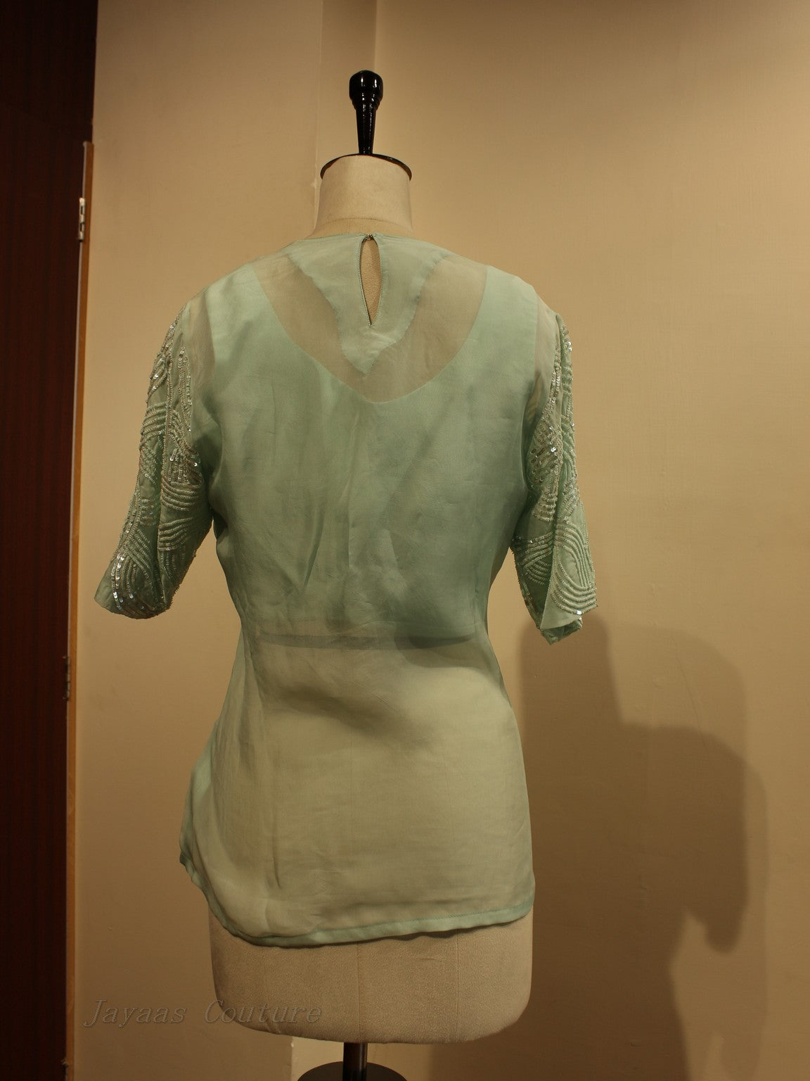 mint green top with flaired pants