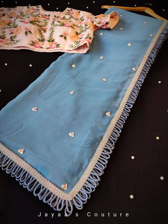 Blue crepe saree with crepe blouse adorned with hand work