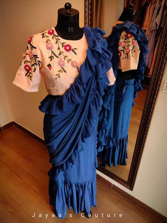 Blue Contemporary Drape Saree Paired with Hand Crafted Peach Blouse.