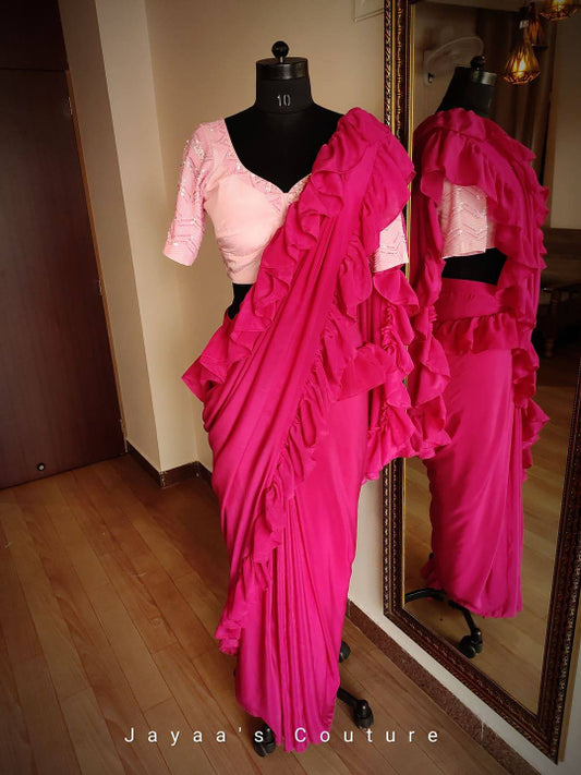 Pink Sequins Hand worked Blouse paired with Rani Georgette Saree designed with Frill.
