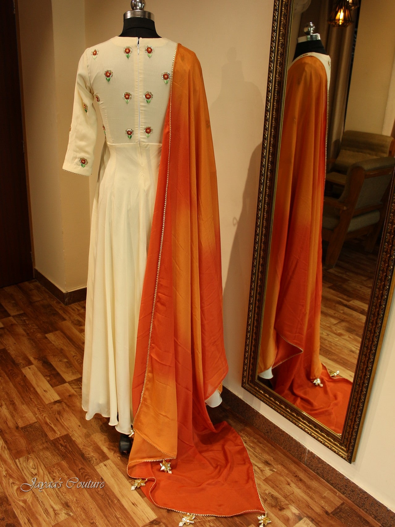 Off white gown with red orange shaded dupatta